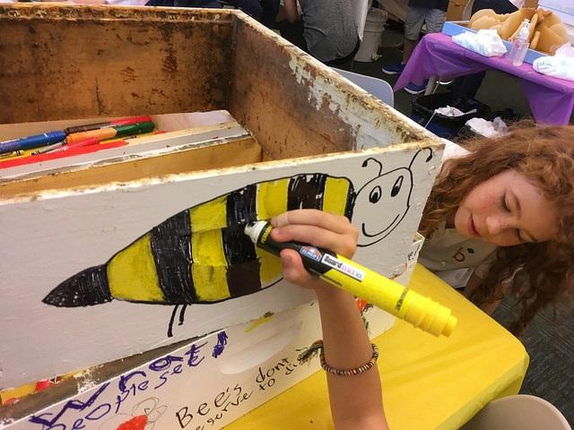 Photo of student drawing a bee